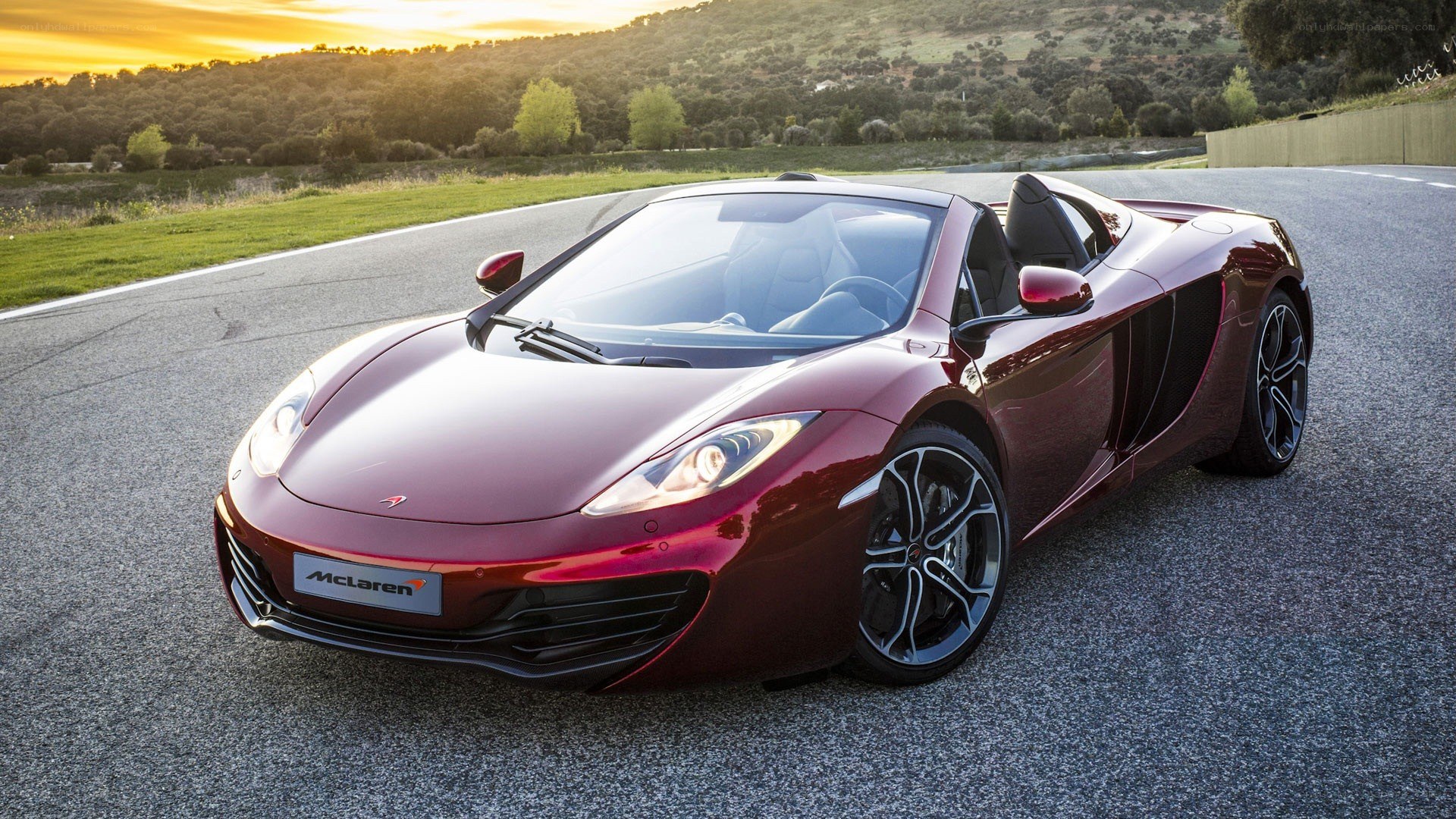 Maroon McLaren on a racetrack