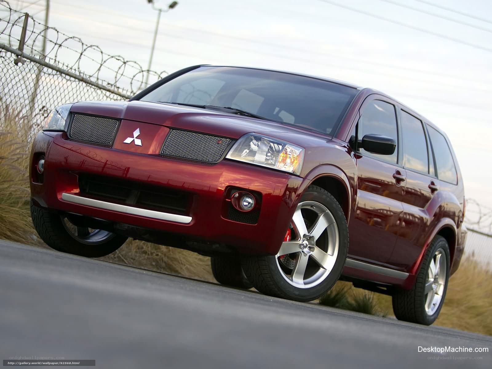 maroon mitsubishi suv on road