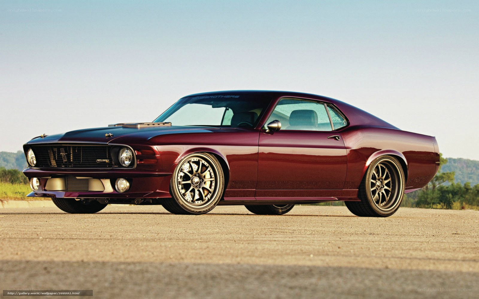 maroon muscle car on road