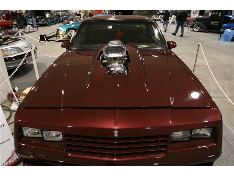 maroon muscle car with supercharger