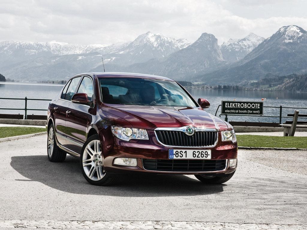 Maroon sedan by a lake