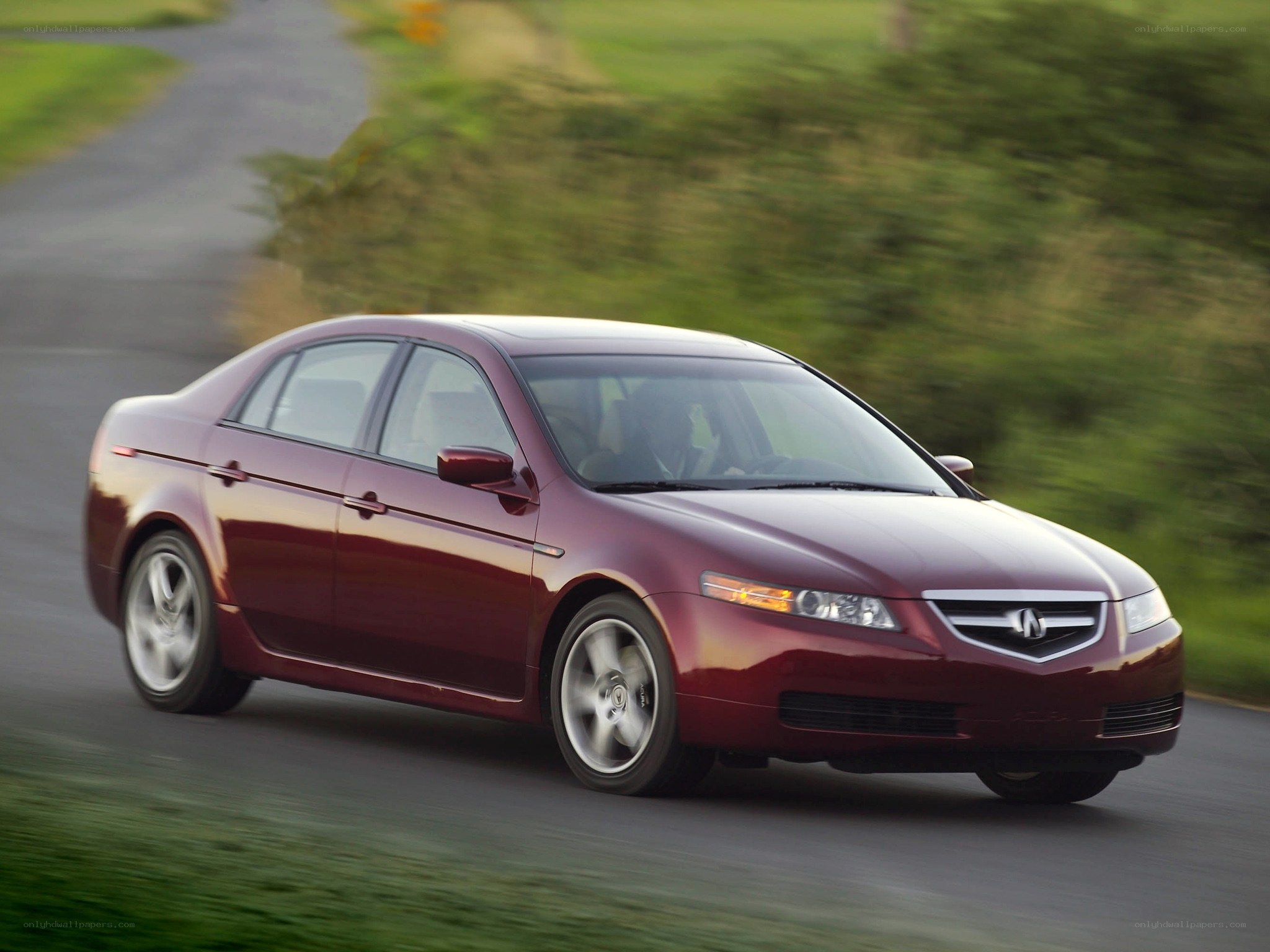 maroon sedan driving on road