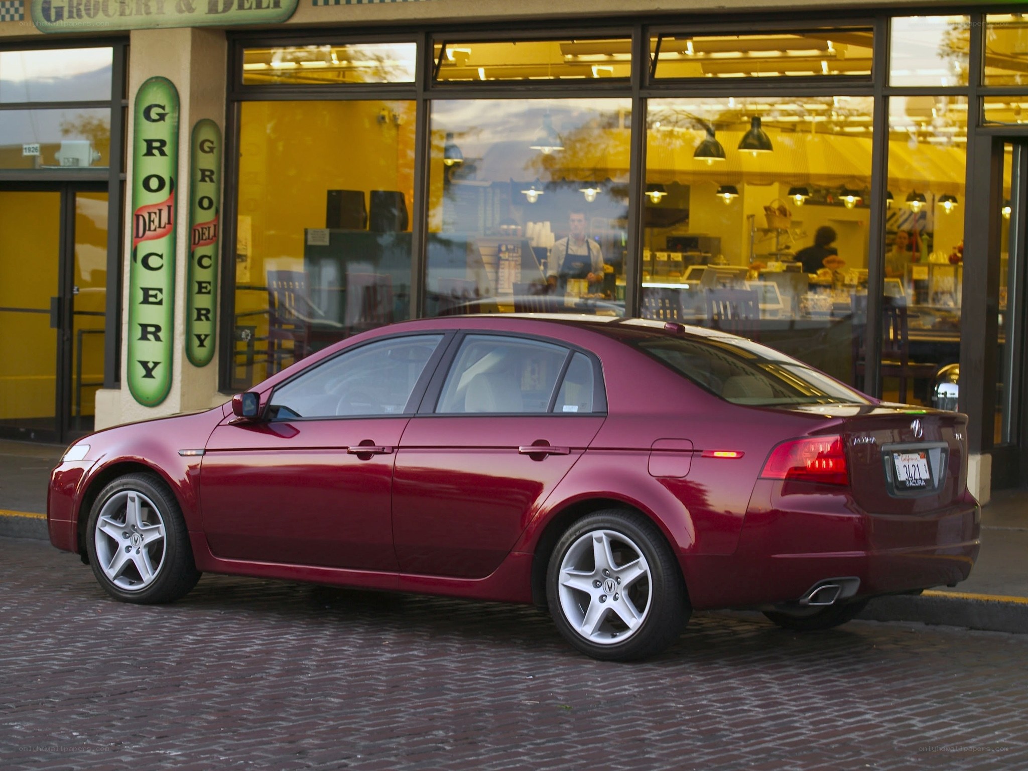 Maroon sedan outside grocery store