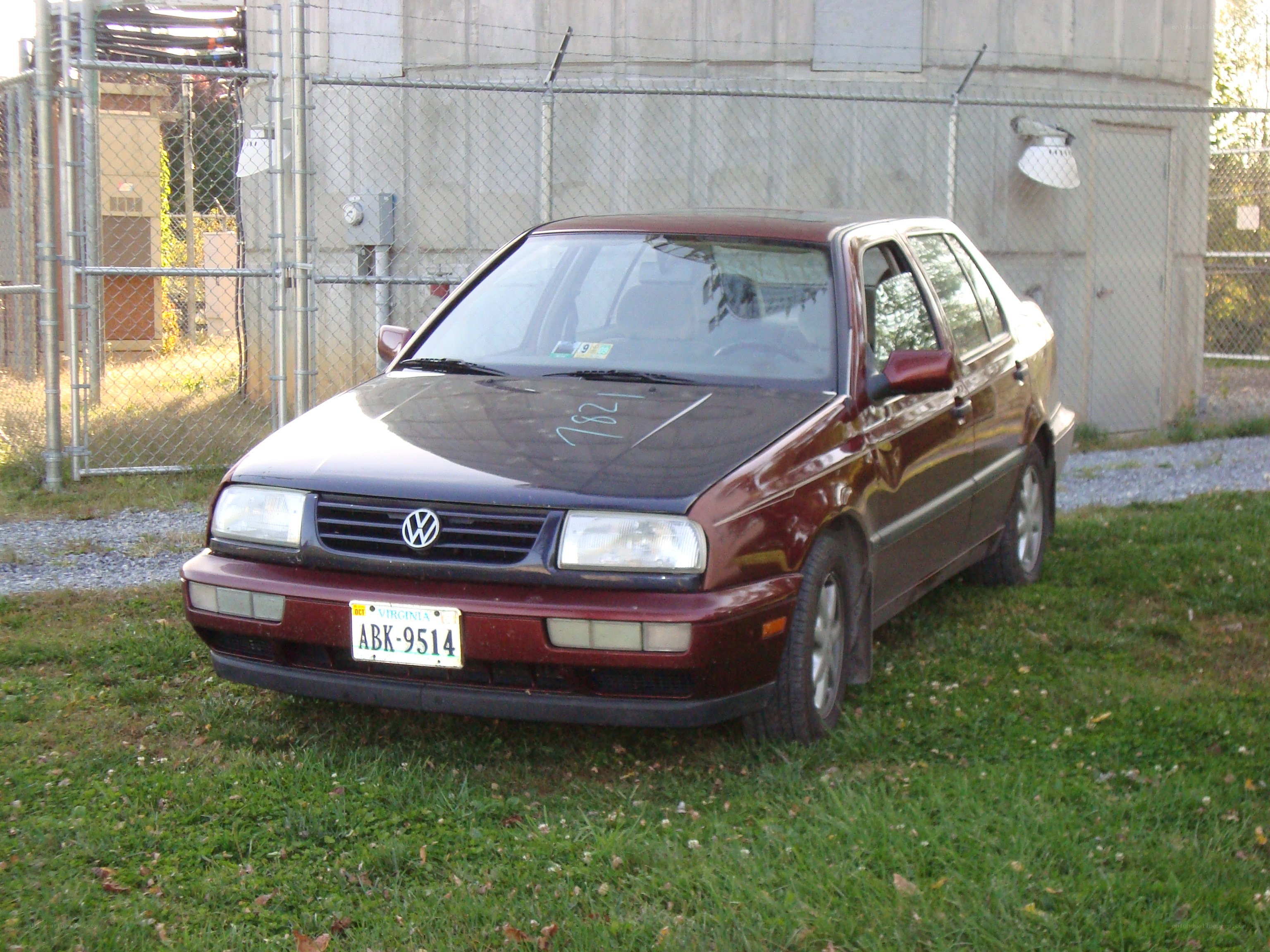 Maroon sedan parked on grass