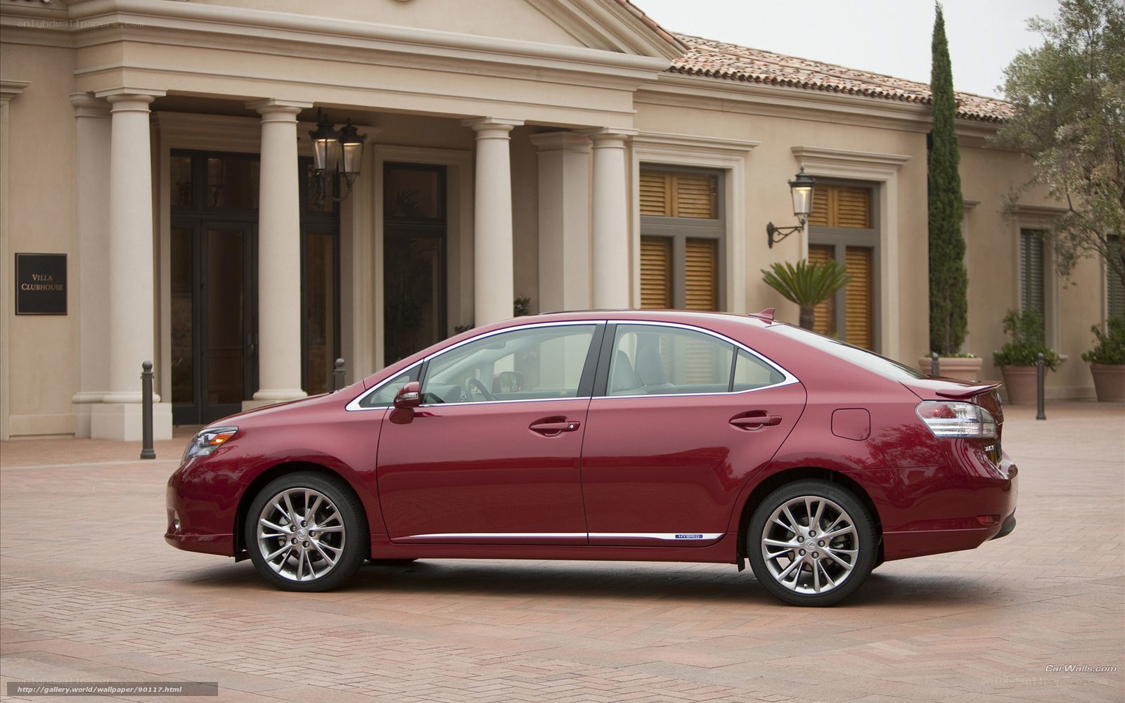 Maroon sedan parked outside villa