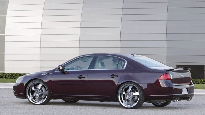 maroon sedan with custom wheels