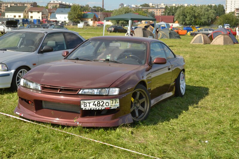 Maroon sports car at outdoor event