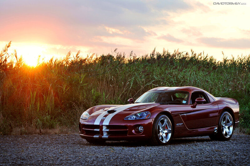 Maroon sports car at sunset