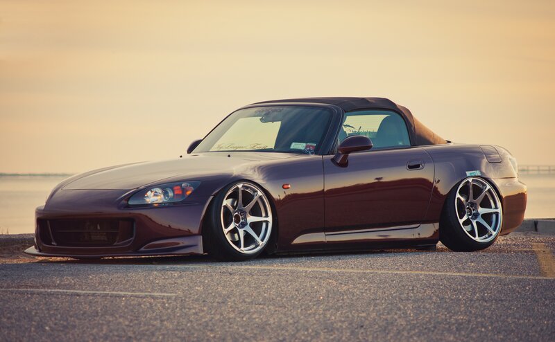 Maroon sports car at sunset