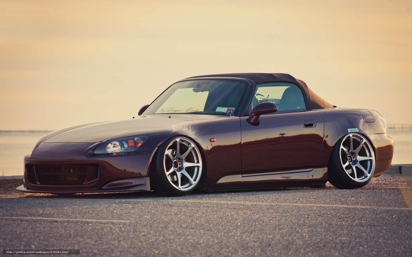 maroon sports car at sunset