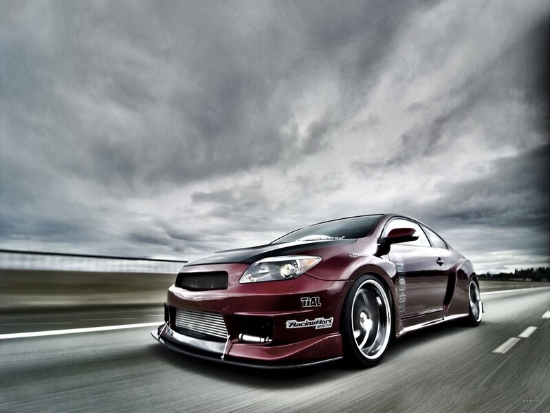 Maroon sports car on a track