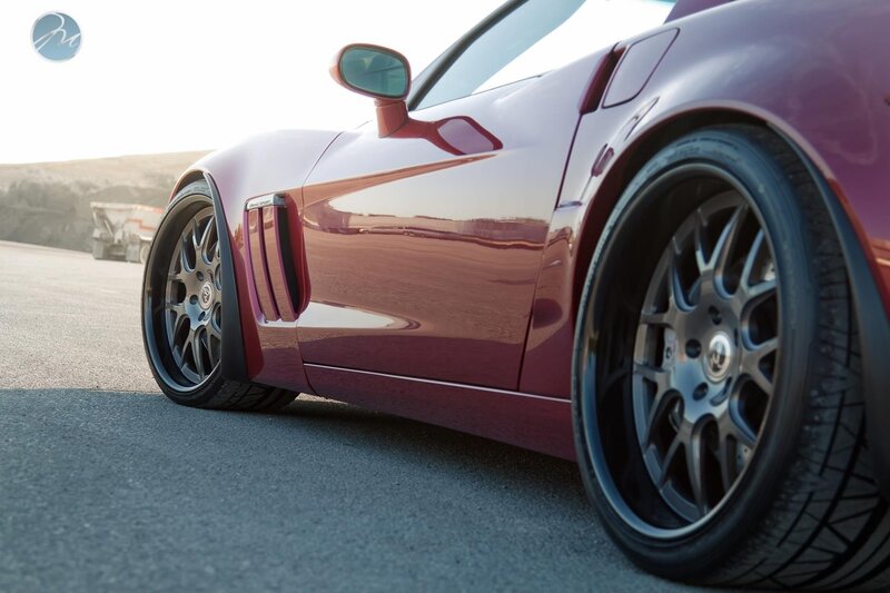 maroon sports car on asphalt