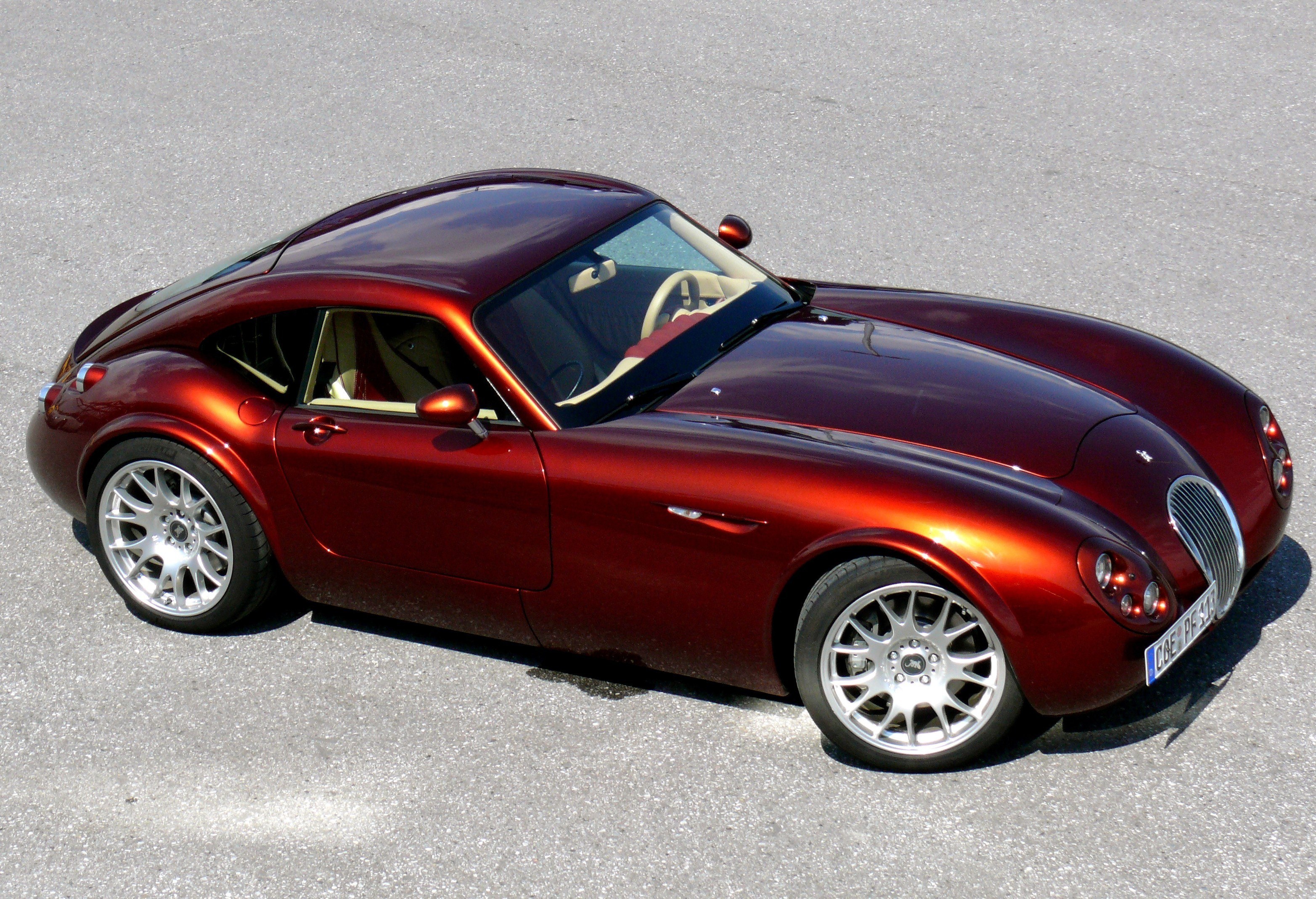maroon sports car on pavement