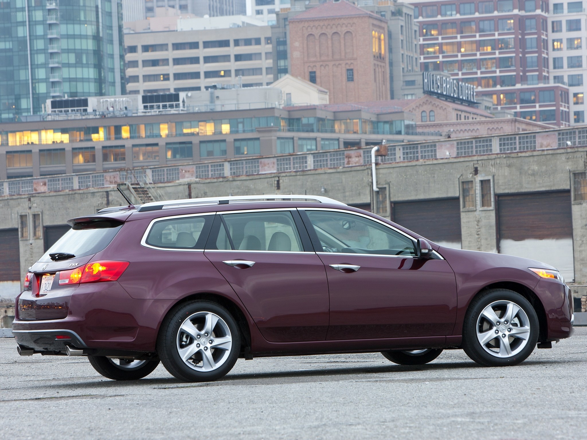 Maroon station wagon in city