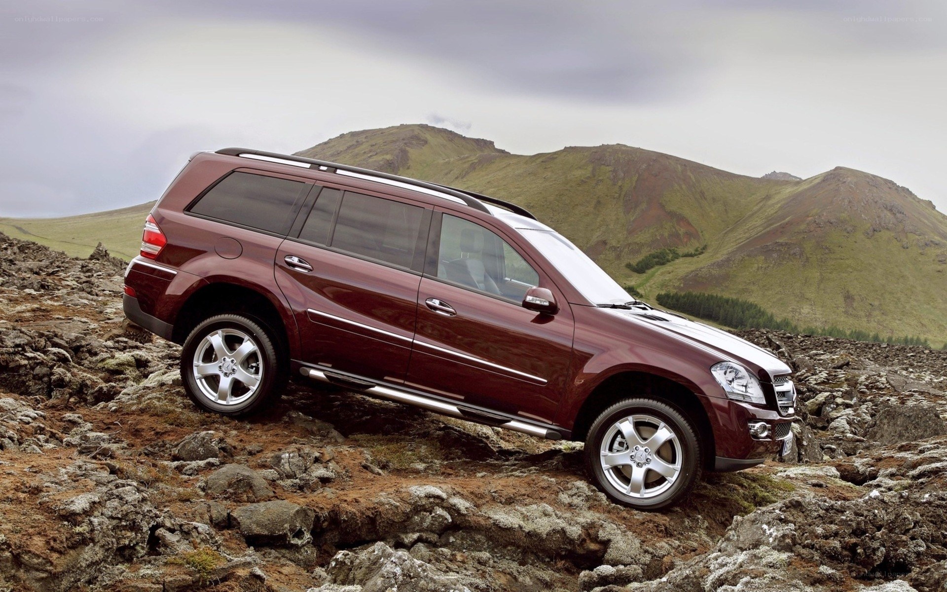 Maroon SUV on rocky terrain