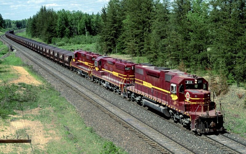 Maroon train in forest