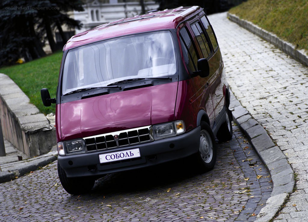 Maroon van on cobblestone street