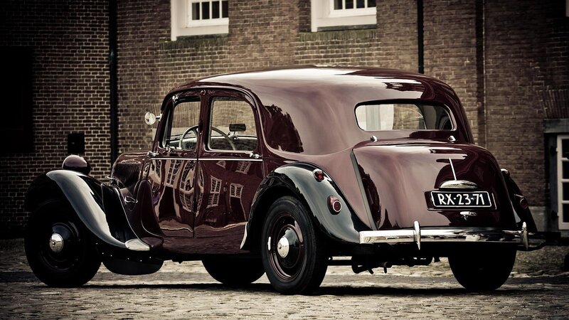 Maroon Vintage Car — Dramatic, Photograph, Brick Building