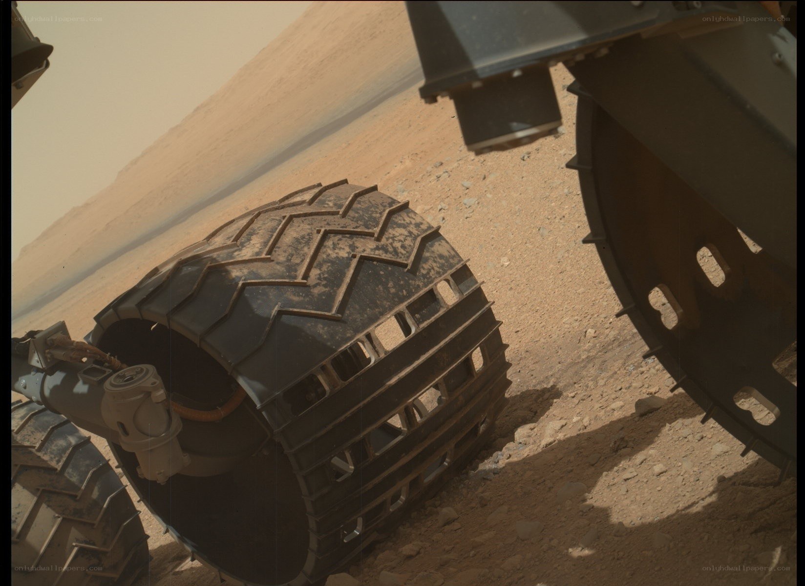 Mars rover wheel on red soil