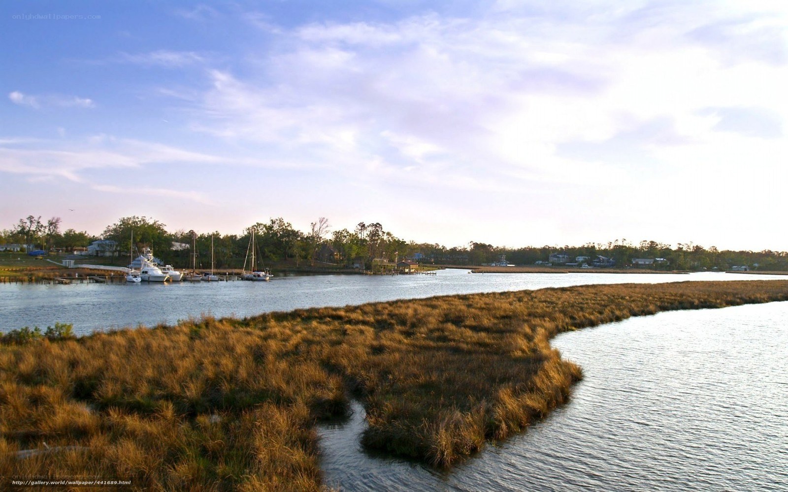 marshland with boats at sunset