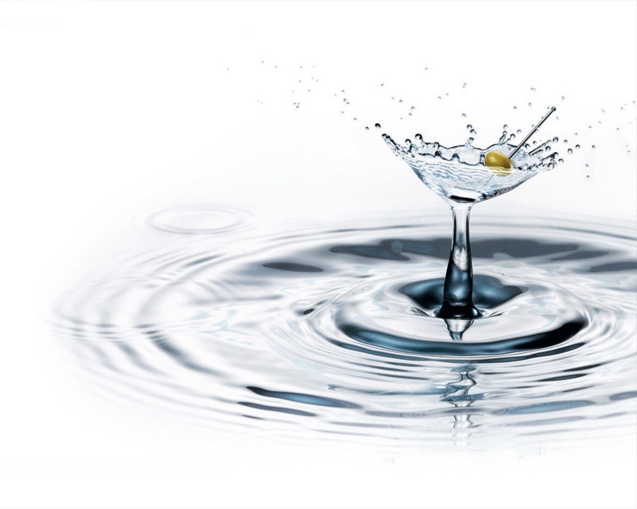 martini glass with olive splash