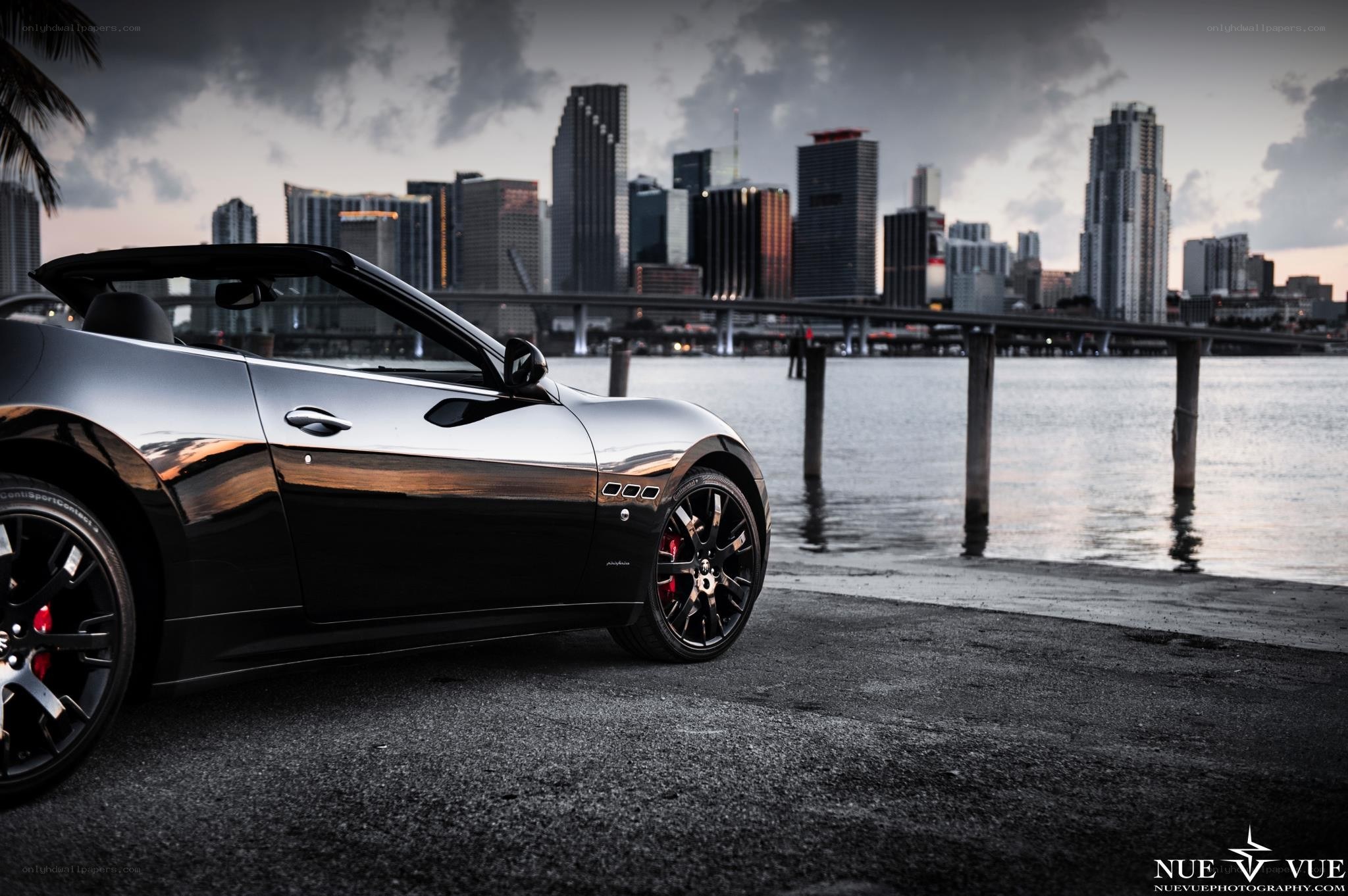 Maserati convertible by city skyline