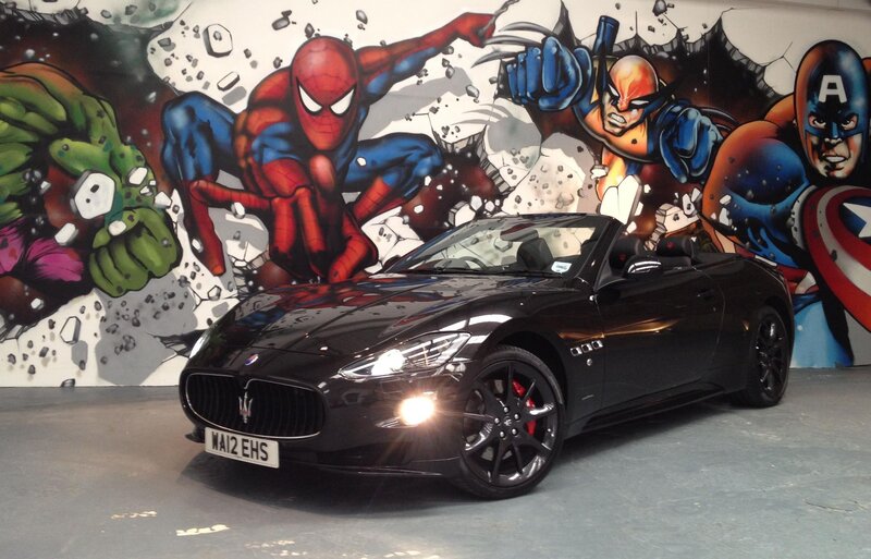 Maserati convertible with superhero mural