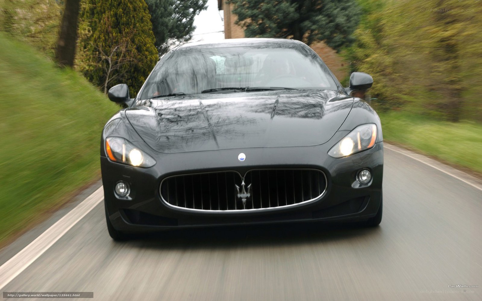 Maserati driving on a road