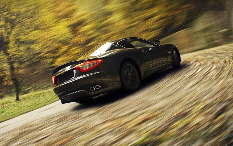 Maserati driving on a winding road