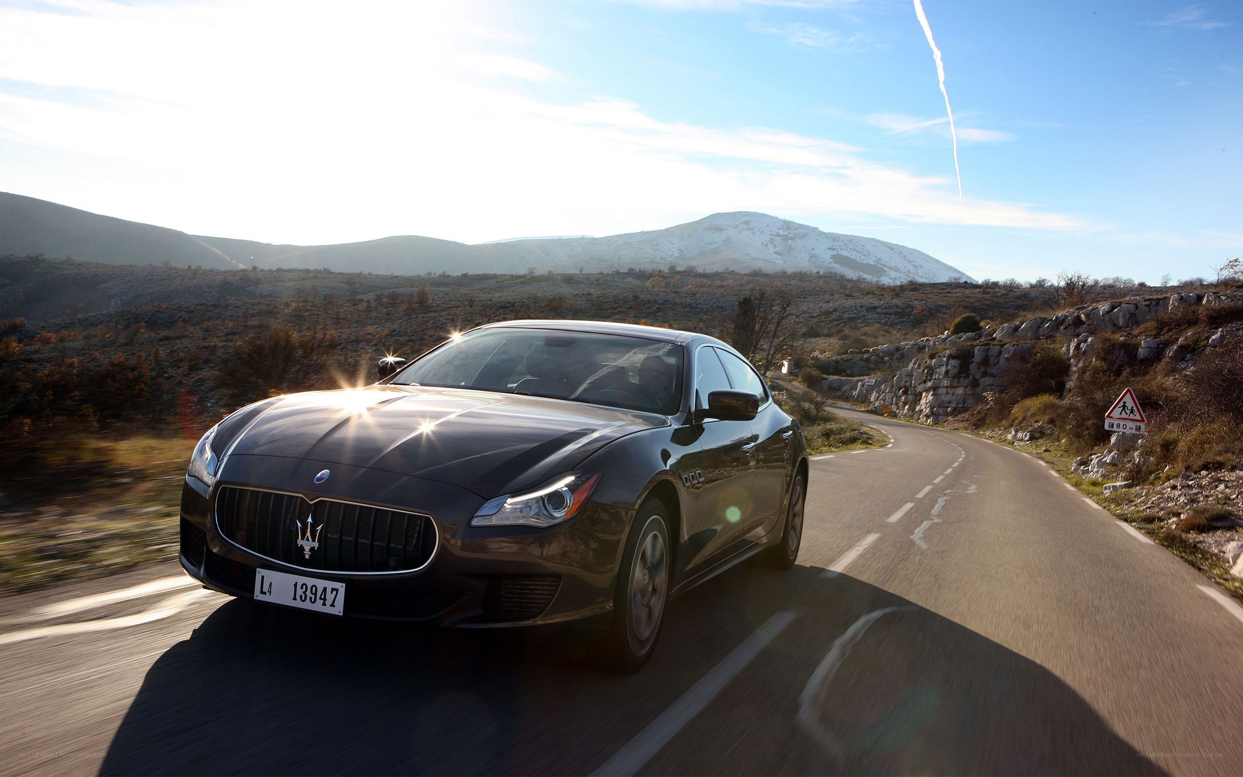 Maserati driving on mountain road