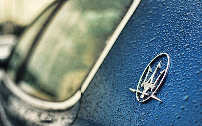 Maserati emblem on wet car