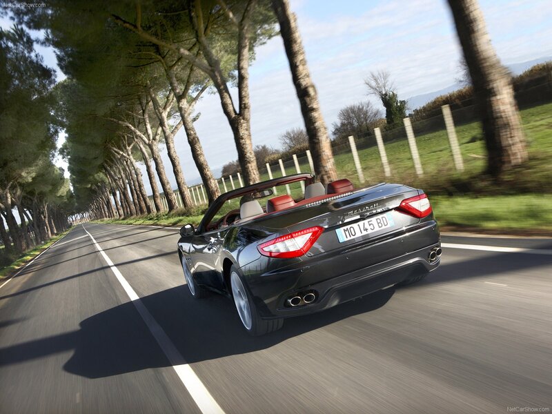 Maserati GranCabrio driving on a tree-lined road