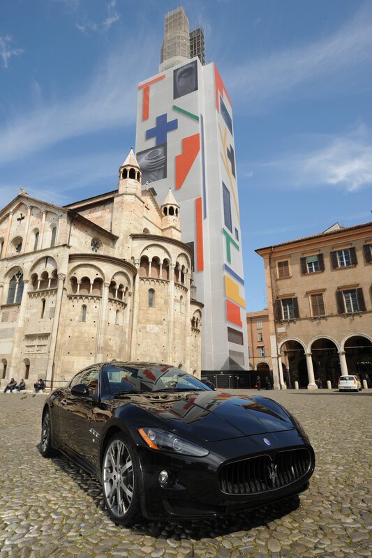 Maserati in front of a tower