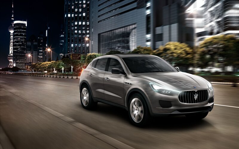 Maserati SUV in city at night