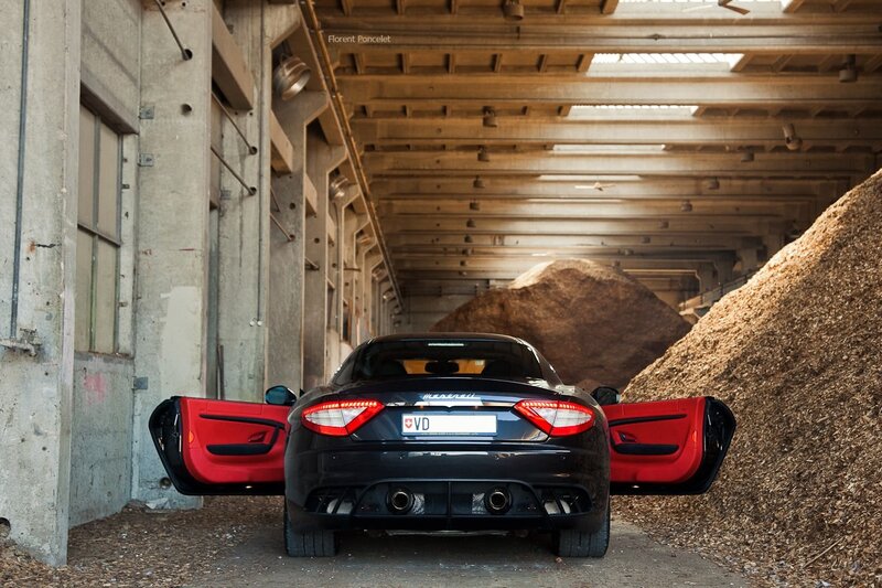 Maserati with open doors in warehouse