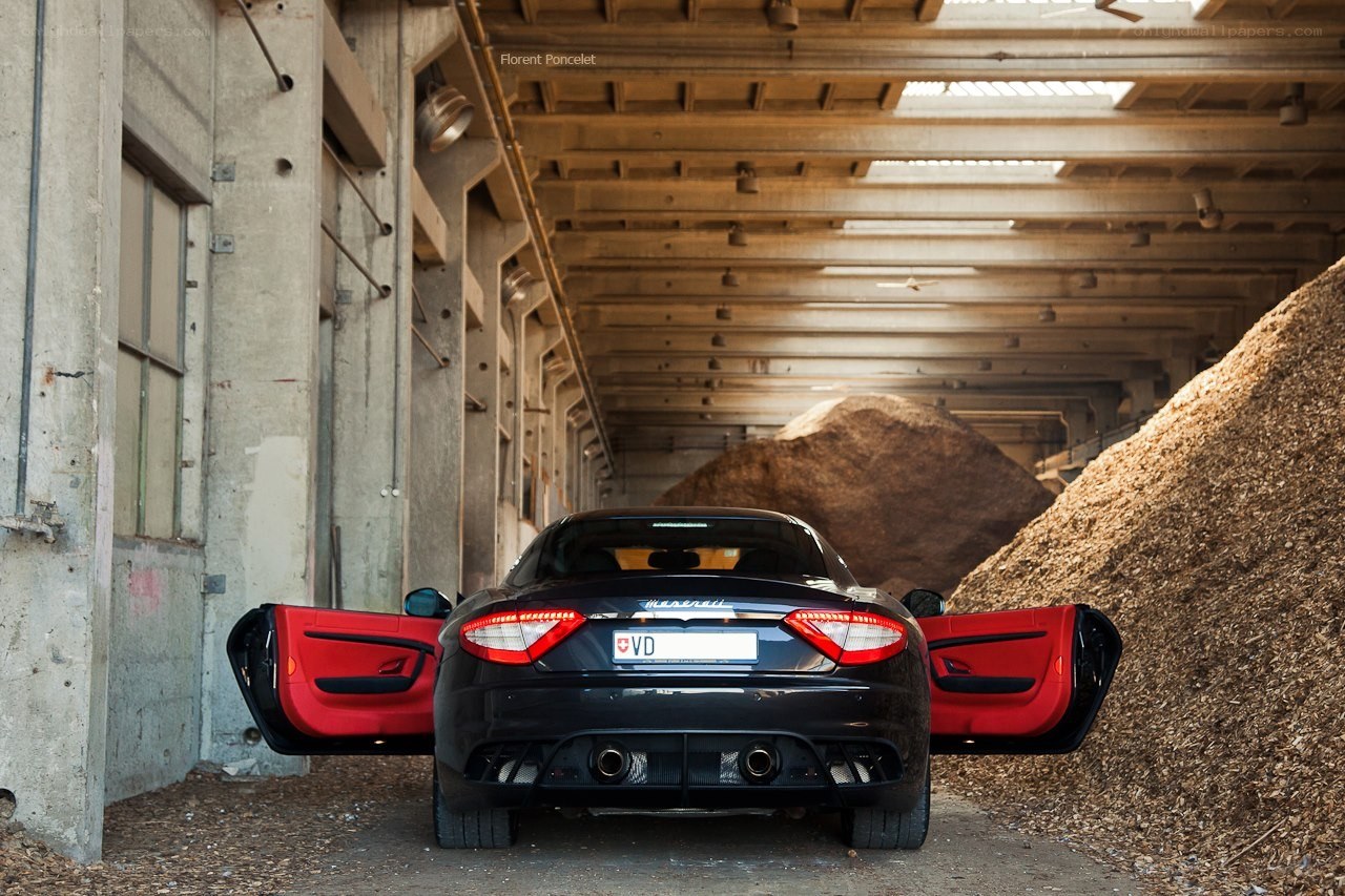 Maserati with open doors in warehouse