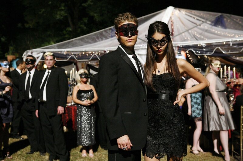 Masked couple at a party