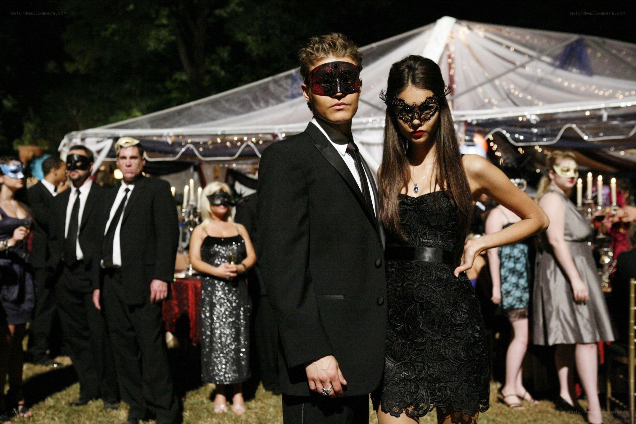 Masked couple at a party