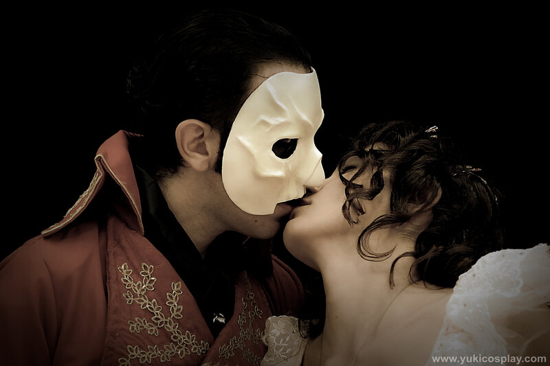 masked couple kissing