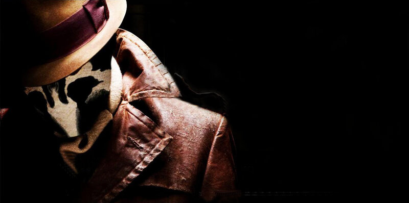 masked figure in trench coat