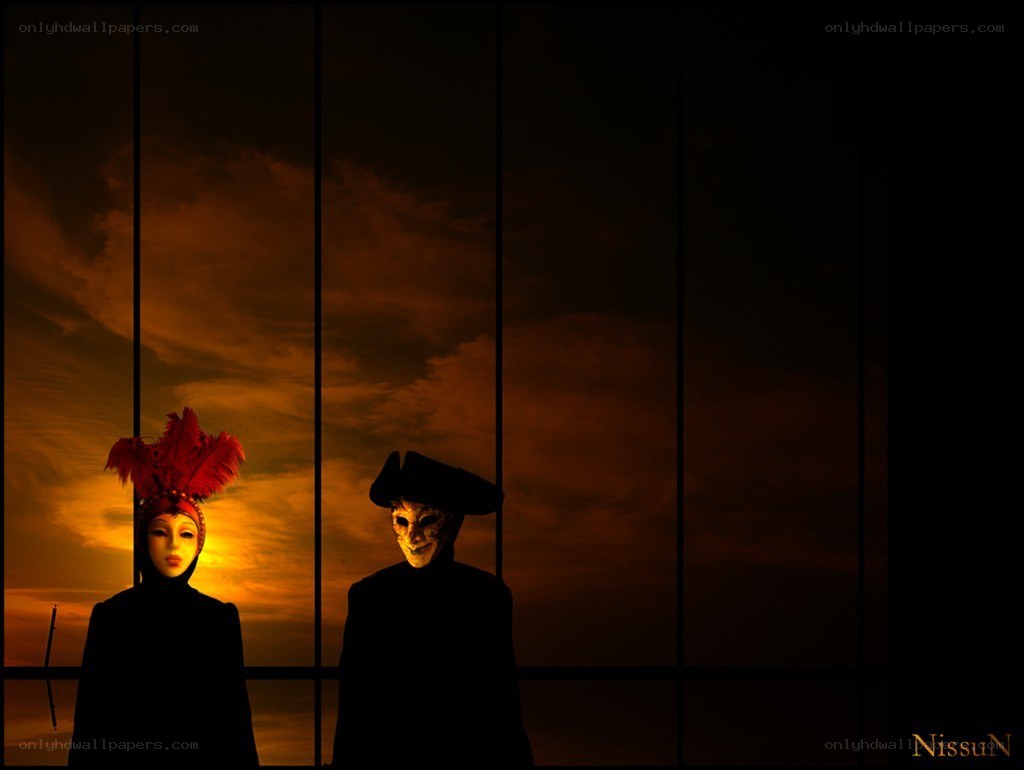 Masked figures at sunset