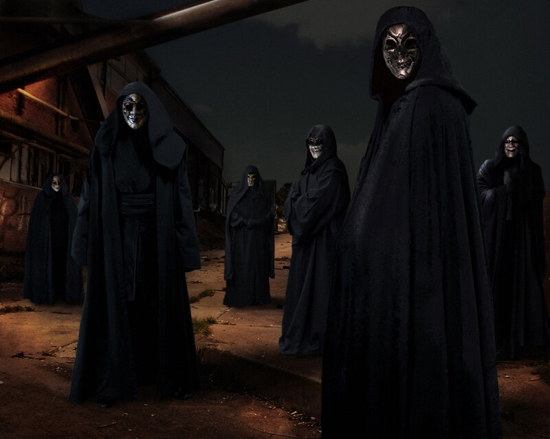 Masked Figures in Cloaks