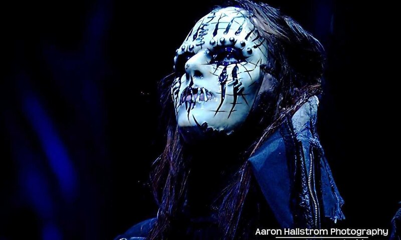 masked performer on stage