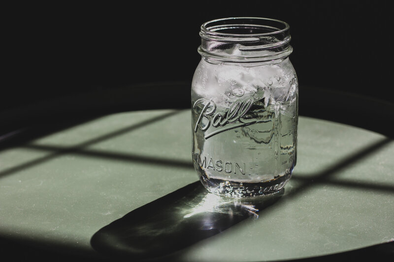 Mason jar with ice on table