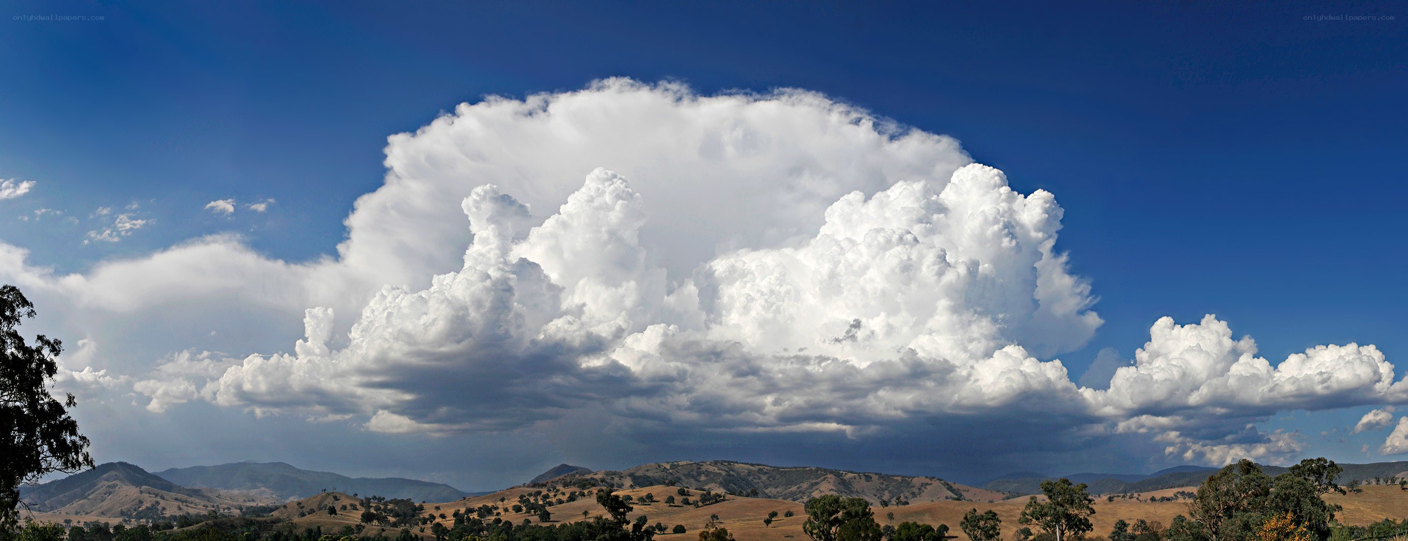 Massive cloud over hills