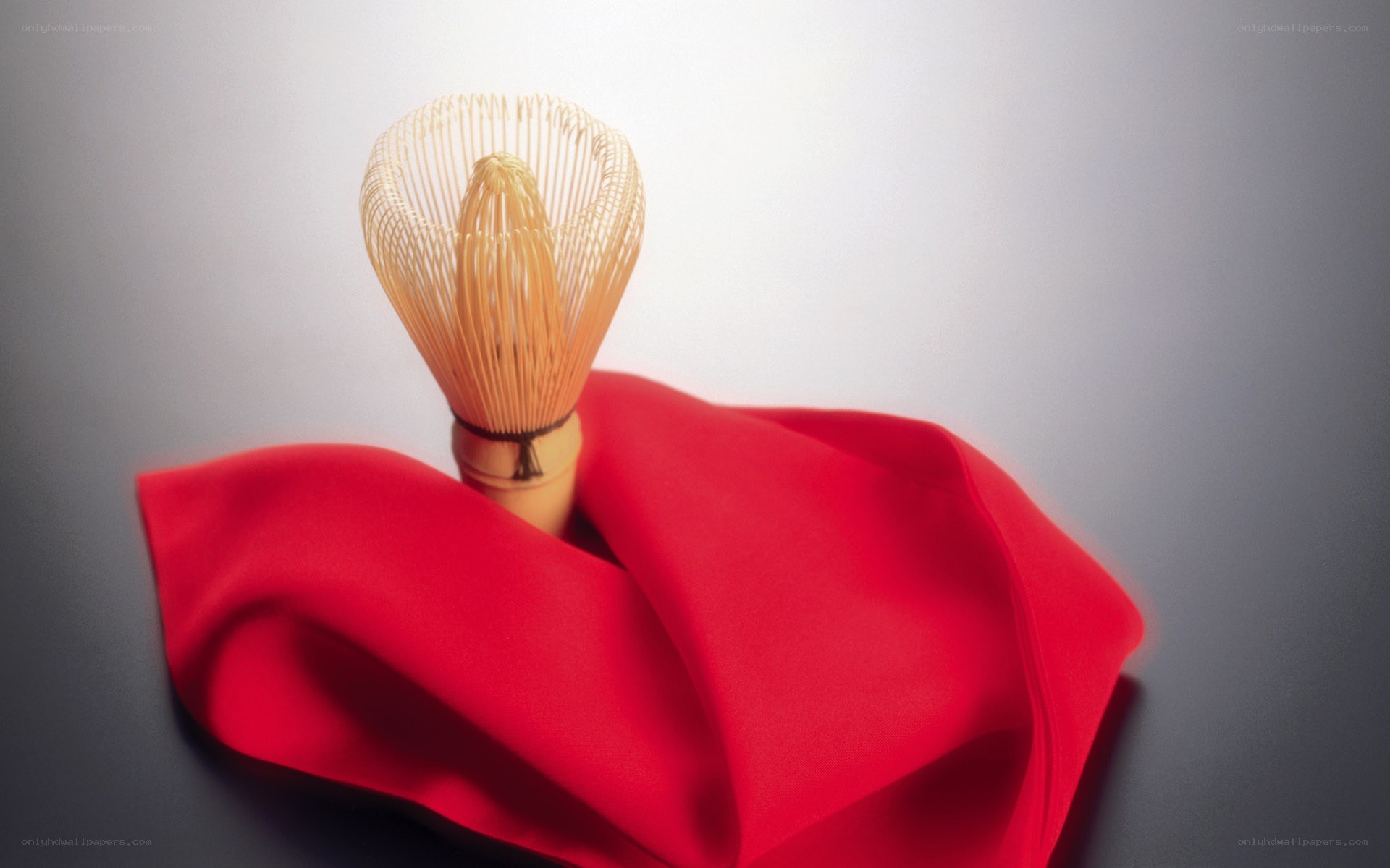 Matcha whisk on red cloth