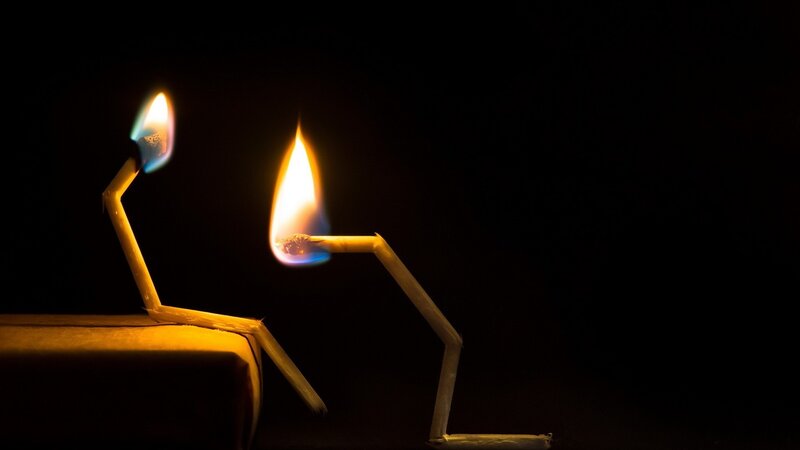 Matchstick figures in flame