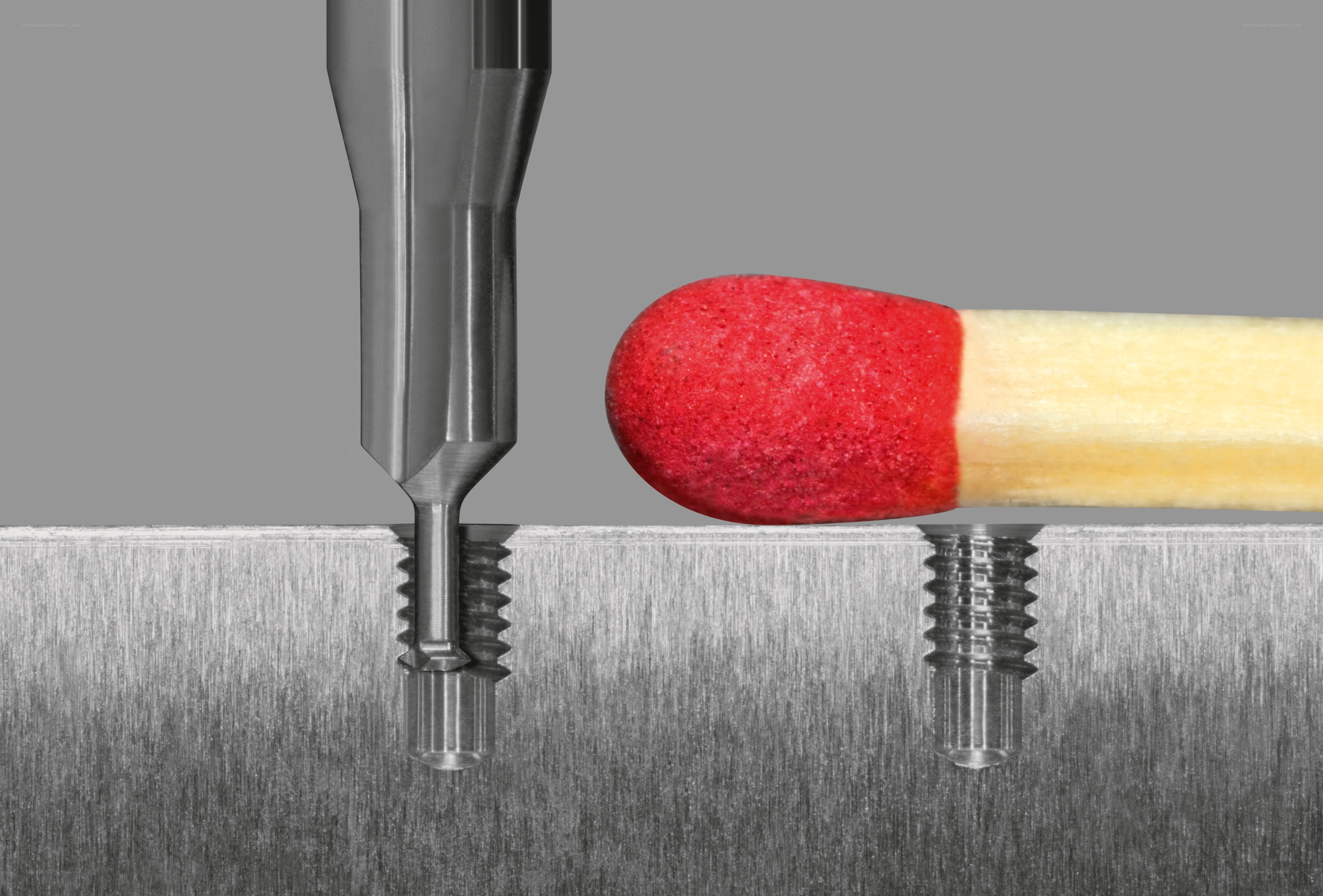Matchstick next to metal drill