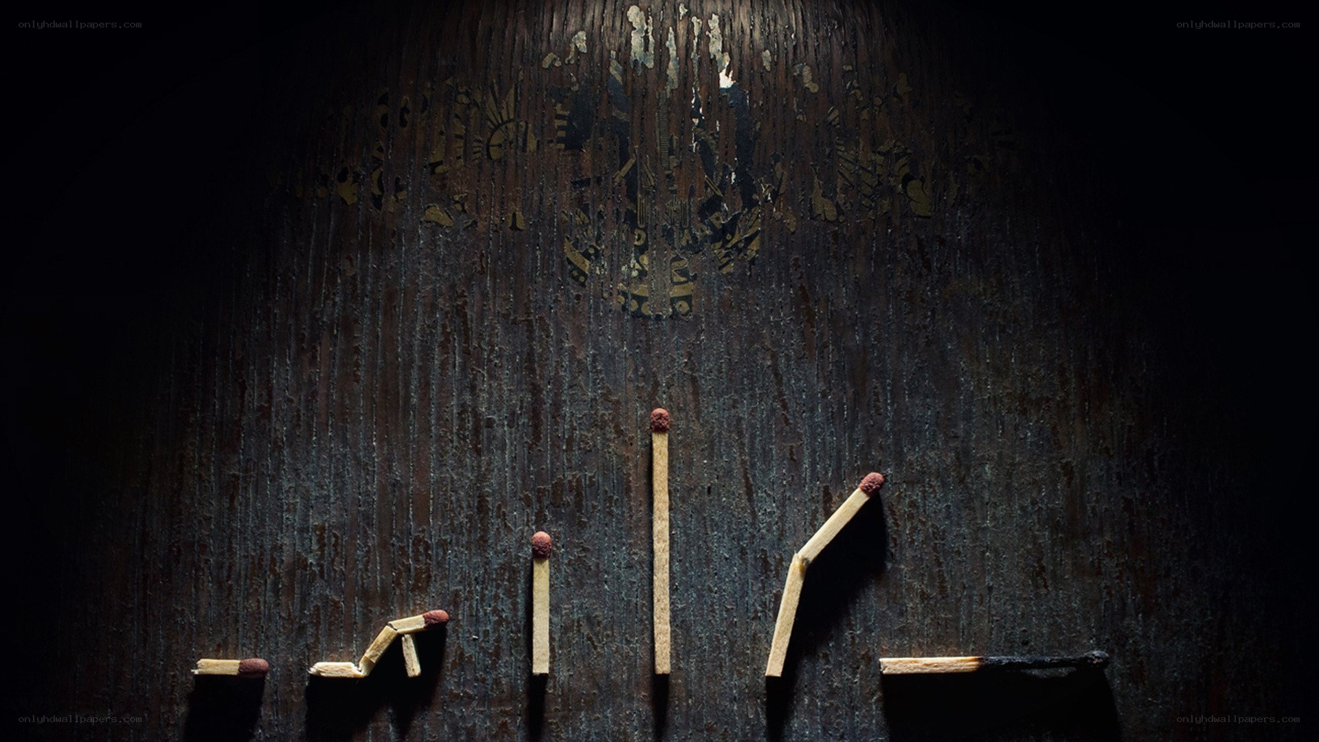 matchsticks on dark wood