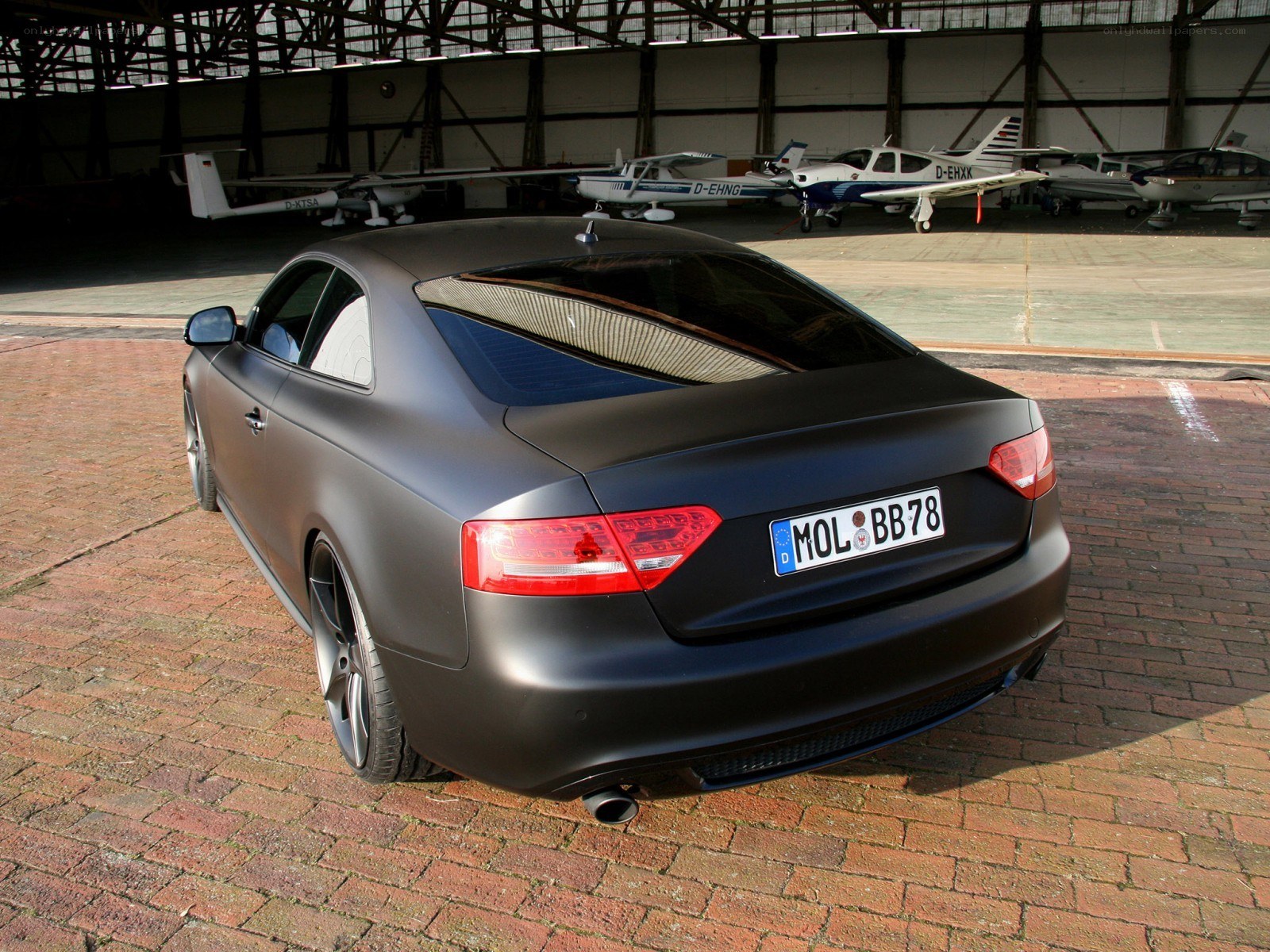 Matte black Audi in hangar